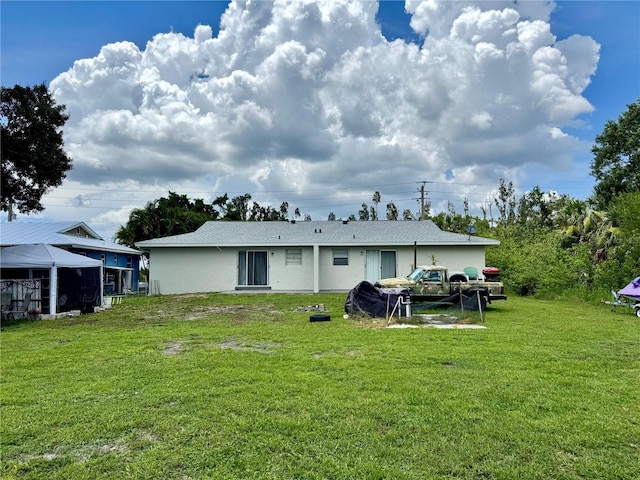 26591 Fairway Dr Unit A & B, Punta Gorda, FL 33982 - back of property with a lawn and stucco siding