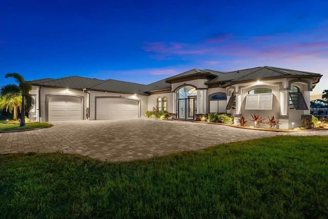 15044 San Domingo Blvd, Port Charlotte, FL 33981 - view of front facade featuring a garage, stucco siding, decorative driveway, and a metal roof