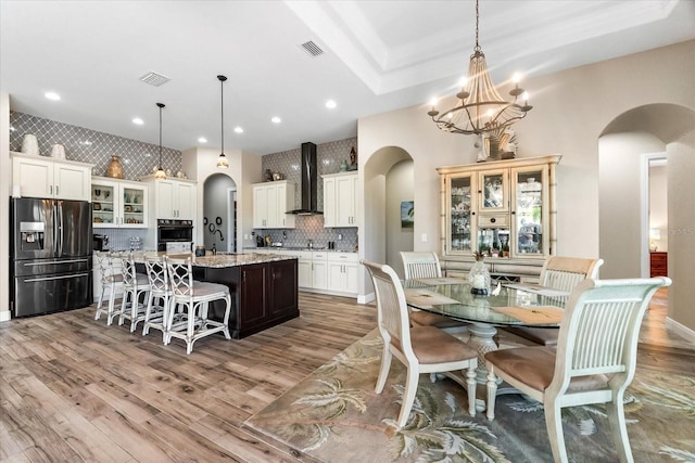 15044 San Domingo Blvd, Port Charlotte, FL 33981 - dining area featuring arched walkways, a chandelier, wood finished floors, and recessed lighting