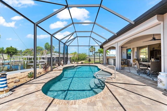 15044 San Domingo Blvd, Port Charlotte, FL 33981 - outdoor pool featuring a patio area, glass enclosure, a water view, and ceiling fan