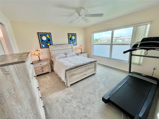 11644 SW Egret Cir Unit 905, Lake Suzy, FL 34269 - bedroom with carpet, a water view, and a ceiling fan
