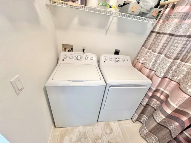 11644 SW Egret Cir Unit 905, Lake Suzy, FL 34269 - laundry area with washing machine and clothes dryer and tile patterned flooring