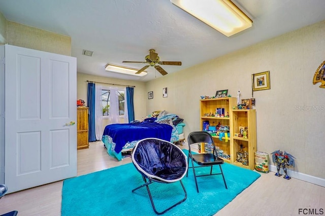 bedroom with ceiling fan and light hardwood / wood-style floors