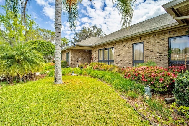 view of side of home featuring a yard