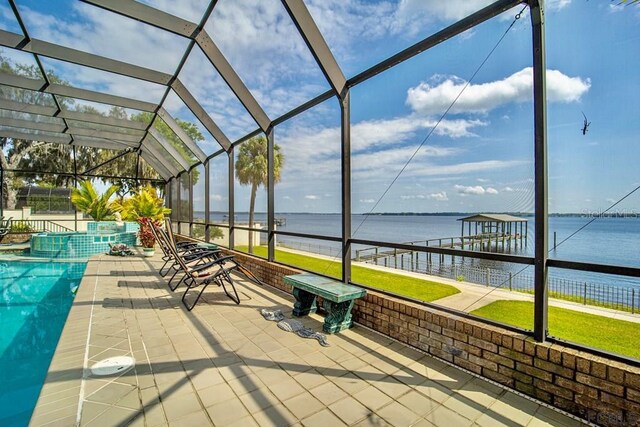 unfurnished sunroom with vaulted ceiling and a water view