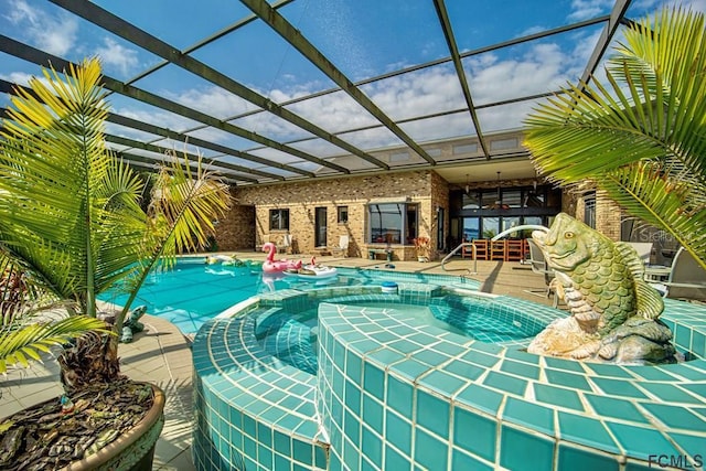 view of swimming pool featuring a patio and a lanai