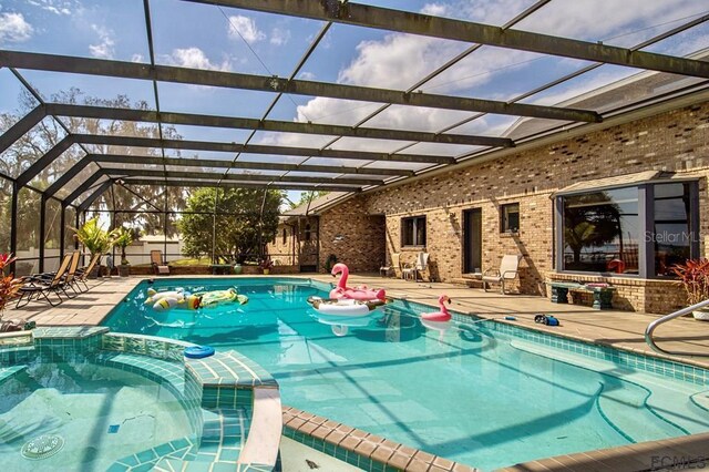 view of swimming pool featuring a lanai and a patio