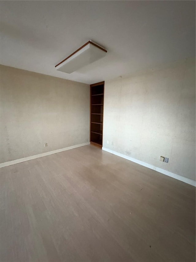 unfurnished room with wood-type flooring