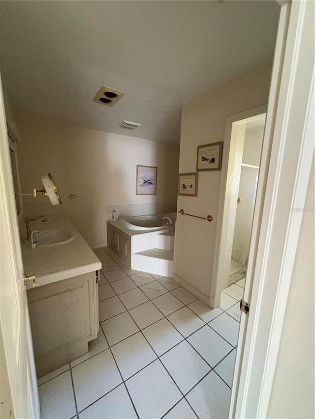 bathroom featuring tile patterned floors, vanity, and a bathtub