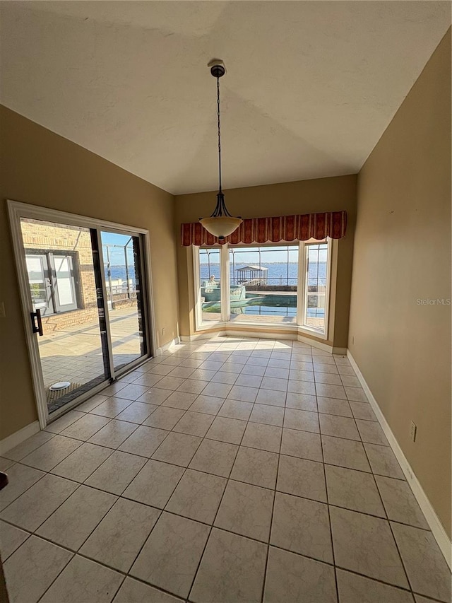 unfurnished dining area with light tile patterned flooring