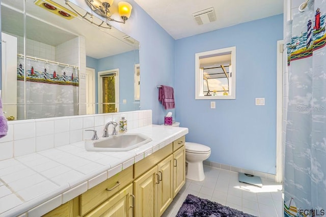 bathroom featuring toilet, vanity, curtained shower, tile patterned flooring, and decorative backsplash