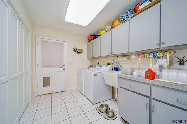 washroom with cabinets, light tile patterned floors, and independent washer and dryer