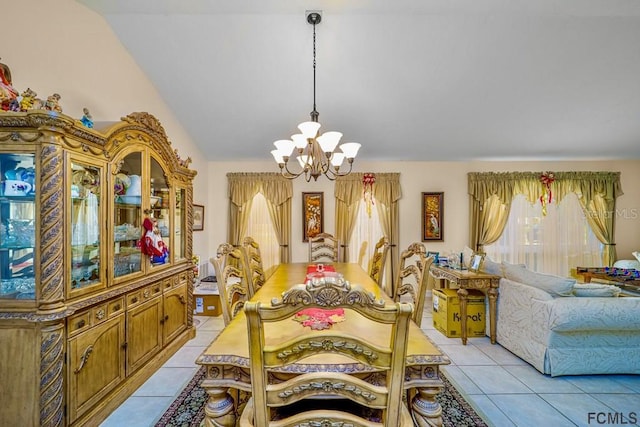 dining space featuring lofted ceiling, light tile patterned floors, and a notable chandelier