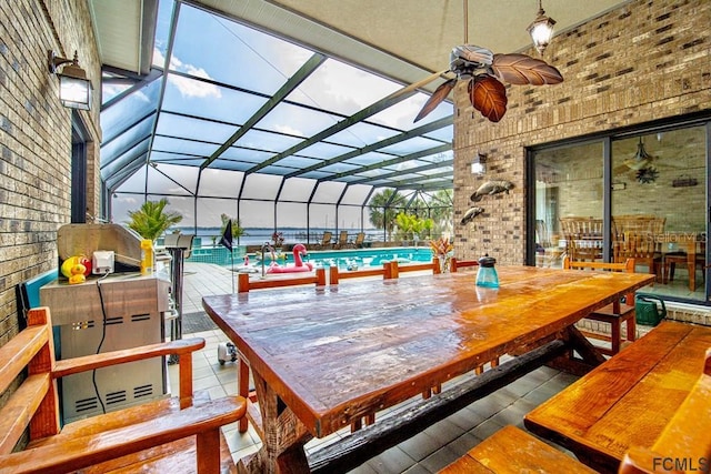 wooden deck with a lanai, a patio area, and ceiling fan