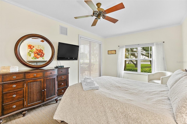 bedroom featuring crown molding, light carpet, and ceiling fan