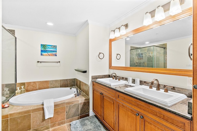 bathroom with ornamental molding, independent shower and bath, and vanity