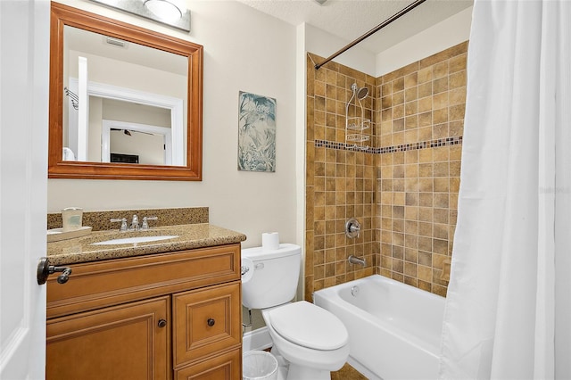 full bathroom featuring shower / bathtub combination with curtain, vanity, a textured ceiling, and toilet