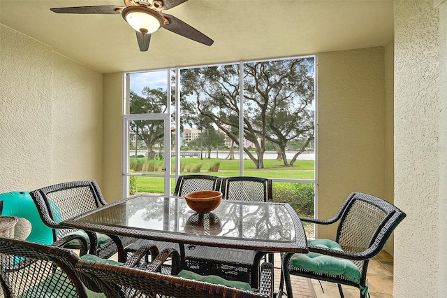 sunroom with ceiling fan and plenty of natural light