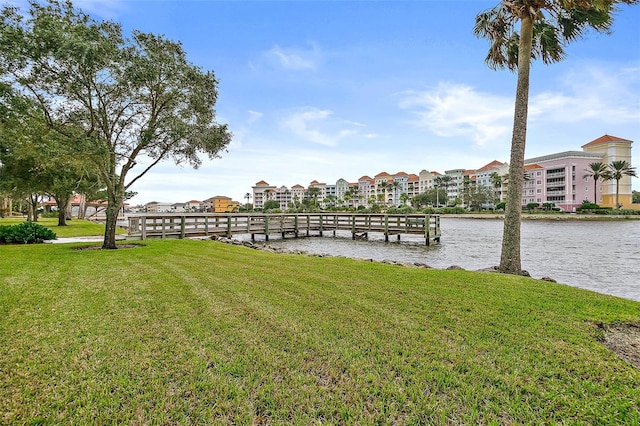 dock area featuring a water view and a lawn