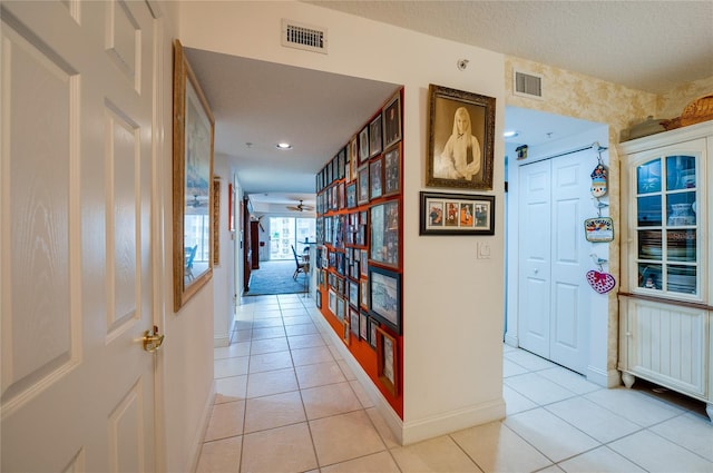 corridor with light tile floors