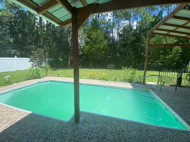 view of pool with a yard