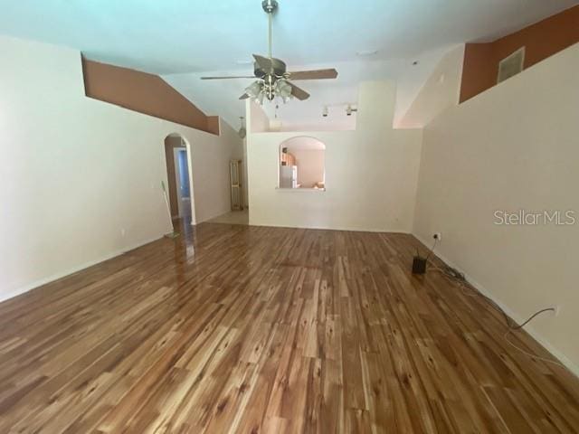 empty room featuring vaulted ceiling, wood-type flooring, and ceiling fan