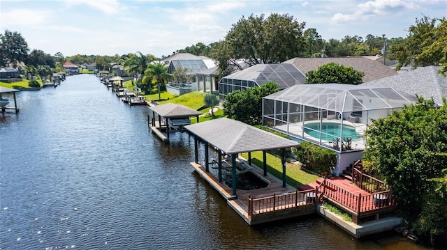 dock area featuring glass enclosure and a pool side deck with water view