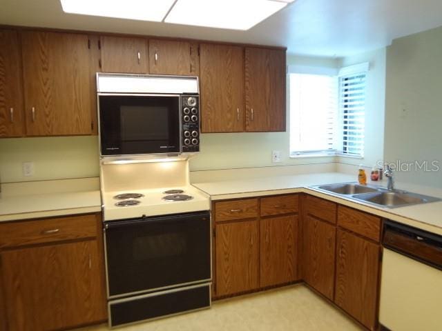 kitchen with white appliances and sink