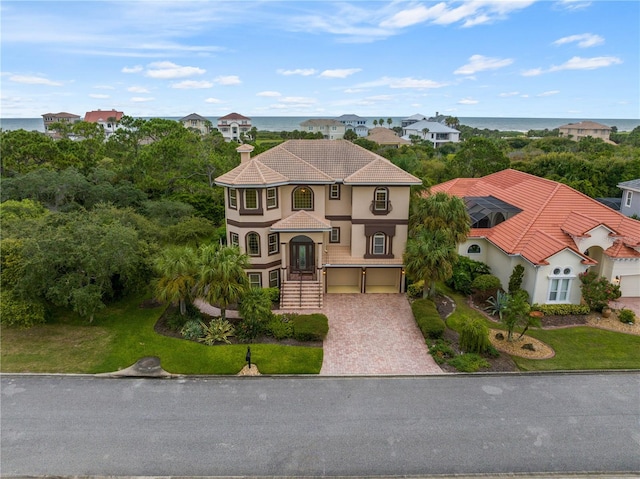 view of front of home with a water view and a garage