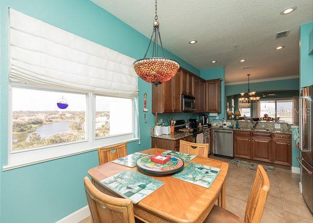 dining room featuring a chandelier, light tile floors, a textured ceiling, crown molding, and sink