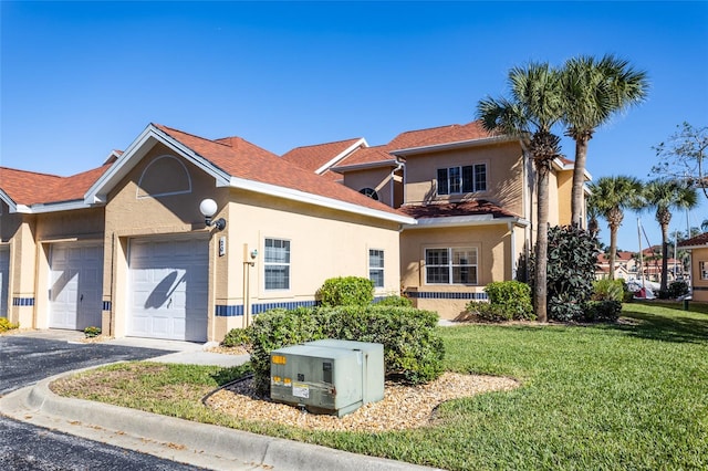 view of front of home with a garage and a front lawn