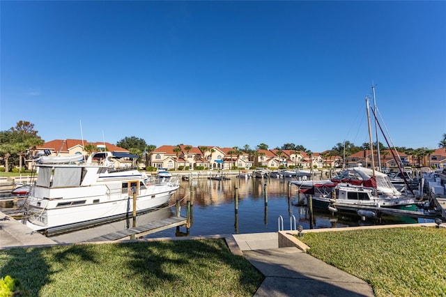 view of dock featuring a water view and a yard