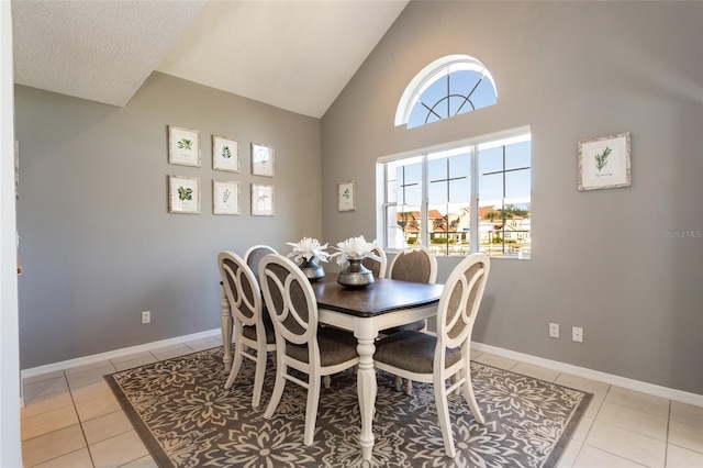 tiled dining space with high vaulted ceiling