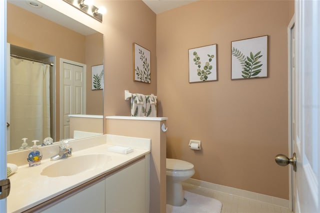 bathroom with tile patterned floors, vanity, and toilet