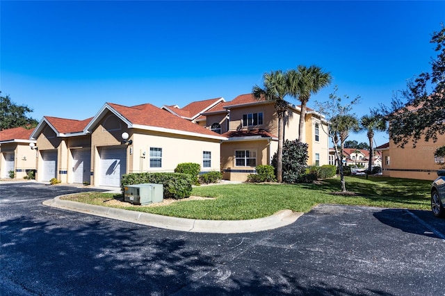 view of front of house with a front yard and a garage