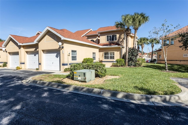 view of front facade featuring a front yard and a garage