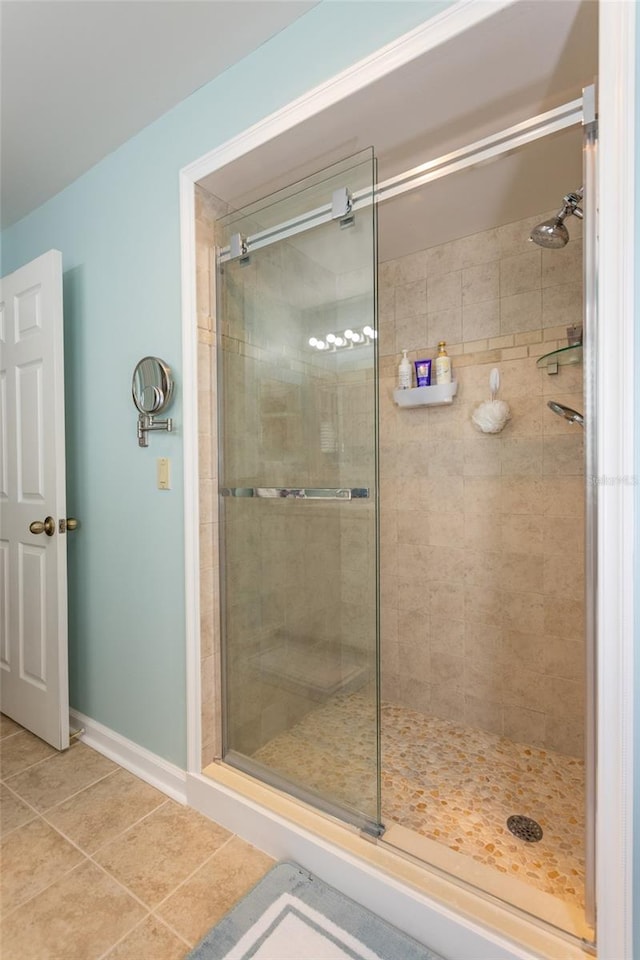 bathroom with tile patterned floors and an enclosed shower