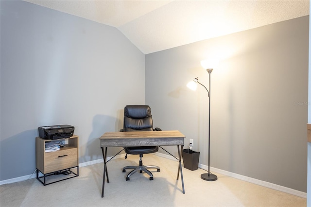 home office featuring light carpet and lofted ceiling