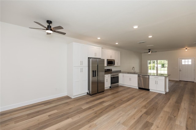 kitchen featuring white cabinets, light hardwood / wood-style floors, stainless steel appliances, and sink