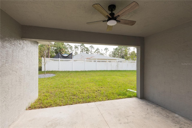 view of yard with a patio area and ceiling fan