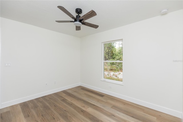 unfurnished room with hardwood / wood-style floors and ceiling fan