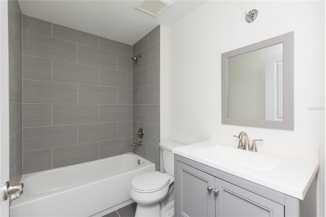 full bathroom featuring toilet, tiled shower / bath combo, vanity, and tile patterned floors