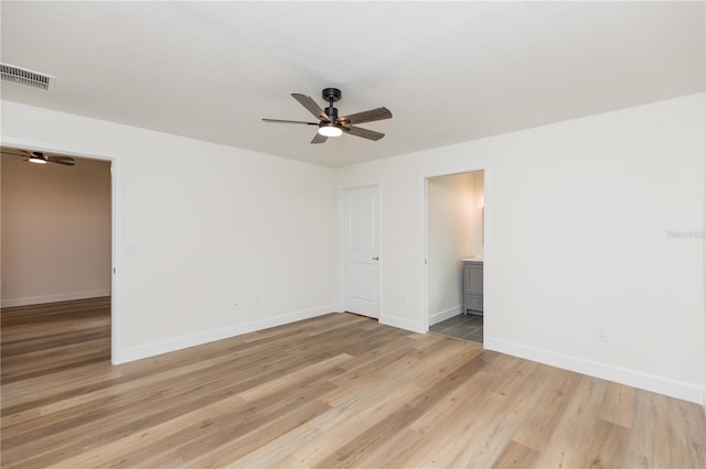 empty room featuring ceiling fan and light hardwood / wood-style flooring