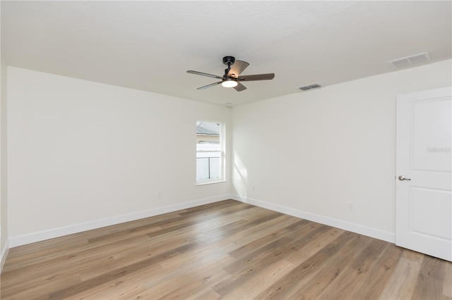 unfurnished room featuring light hardwood / wood-style floors and ceiling fan