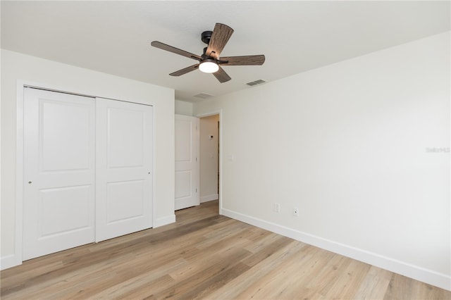 unfurnished bedroom with a closet, ceiling fan, and light hardwood / wood-style floors