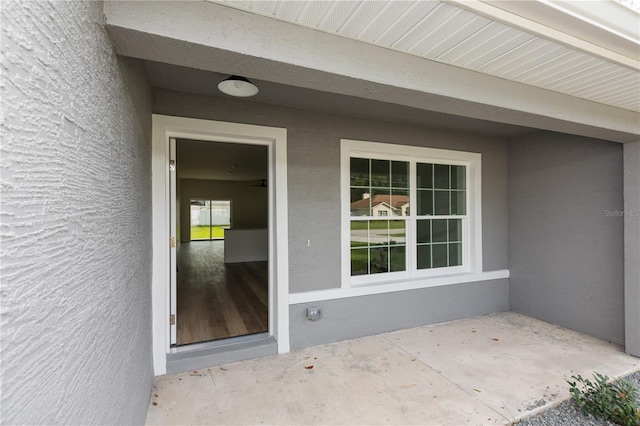 view of exterior entry featuring a patio