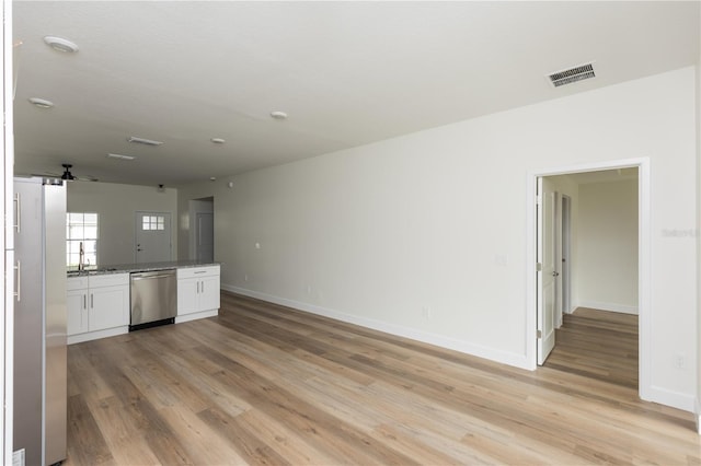 kitchen featuring stone countertops, white cabinetry, light hardwood / wood-style flooring, white refrigerator, and dishwasher