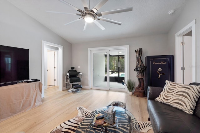 living room with lofted ceiling, light hardwood / wood-style floors, and ceiling fan