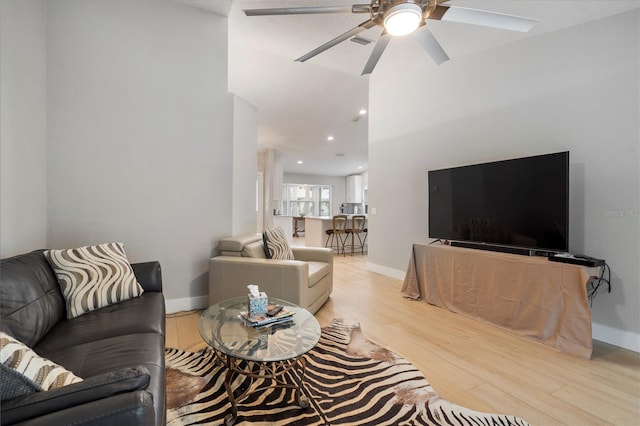 living room featuring light hardwood / wood-style floors and ceiling fan