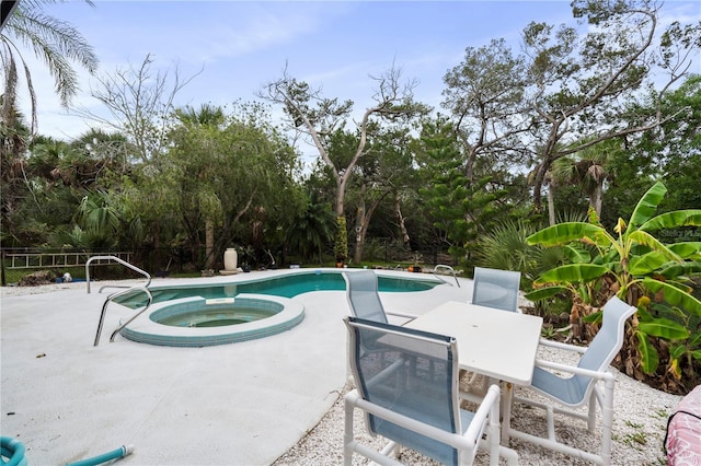 view of pool featuring an in ground hot tub and a patio area